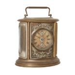 A German brass oval alarm clock, 20th century, the circular dial with Roman numerals and two