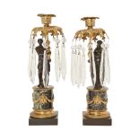 A pair of Regency gilt-metal and patinated bronze candlesticks, c.1820, modelled as a male and