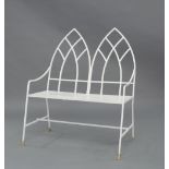 A Gothic style cast iron bench, 20th century, white painted with twin pointed arch shaped backrests,