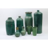 A group of eight green-glazed stoneware vessels, 19th and 20th century, comprising: two tall