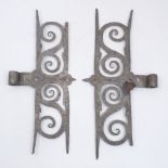 A pair of wrought-iron hinge plates, possibly 18th century, each of pierced scroll design, 41cm high