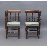 A pair of Victorian mahogany child’s corner chairs, with spindle back rest and turned supports, 56cm
