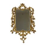 An 18th century carved gilt wood mirror, rectangular glass, the frame with 'C' scroll cresting,