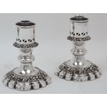 A pair of silver plated candlesticks, Barker Ellis, each with pierced sconce above bands of grape