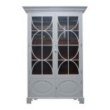 A modern white painted larder cabinet, from Chalon with stepped cornice above two glazed doors and