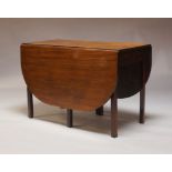 A mahogany drop leaf dining table, late 19th, early 20th Century, the rounded rectangular top on