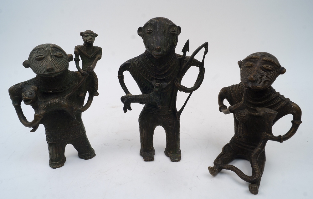 A group of three West African stylised cast brass figures, 20th century, to include: a seated figure