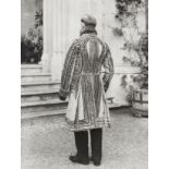 British School, early-mid 20th century- Man standing full-length wearing an embroidered house