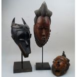 Three African masks, including: a Guro Zamble style mask, Cote d'Ivoire, depicting a mythical figure
