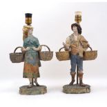 A pair of French cold painted figural lamps, early 20th century, modelled as a man and lady carrying