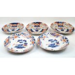 A group of five Japanese Imari plates, 20th century, comprising a pair centered by a pagoda and