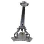 A Continental white metal candlestick, 19th century, the tapered hexagonal stand on dolphin supports