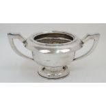 A filled silver twin handled trophy cup, Chester, 1911, E J Trevitt & Sons, on circular foot, 14cm