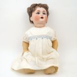 A Schutzmeister & Quendt 201 bisque headed doll, on bent limbed composition body, approx. 54cm highA