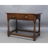 A George III oak side table, with single drawer, raised on fluted legs joined by stretchers