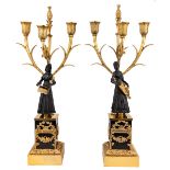 A pair of Louis-Philippe gilt and patinated bronze three-light figural candelabra, c.1840, one