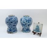Two Delft octagonal baluster jars, late 18th century, the bodies decorated with flowers, 27cm and