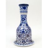 A Persian pottery hookah base, 20th century, densely decorated overall with flowers and leaves, 26cm