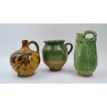 A green glazed jug, 20th century, the handle with dot decoration, 24cm high; together with a green-