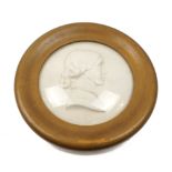 After Thomas Woolner R.A., English, 1825-1892, a Victorian painted plaster portrait roundel of Emily