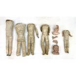 A doll restorer’s lot of cloth and kid leather dolls bodies, together with an assortment of dolls