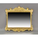 A George I style giltwood over mantle mirror, early 20th century, shell, floral and C scroll border,