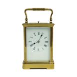 A gilt-brass repeating carriage clock, 20th century, the corniche case white enamel dial having