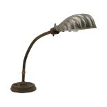An adjustable brass table lamp, early to mid 20th century, with nickel plated shell form shade