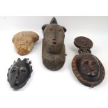 Four African masks, to include a mask with elaborate coiffure, possibly Yaure, 45cm high; a