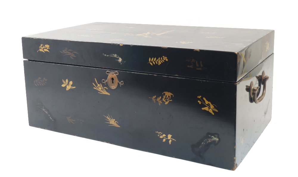 A Japanese black lacquer chest, gilt decorated to the exterior with floral sprays, the hinged lid