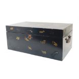 A Japanese black lacquer chest, gilt decorated to the exterior with floral sprays, the hinged lid
