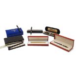 A collection of pens, to include: a les must de Cartier 18kt gold plated ball point pen, serial