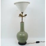 A Chinese celadon table lamp, 20th century, converted to electricity, on pierced hardwood base, 55cm