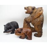 A large Japanese carved wood model of brown bear, 20th century, standing with one paw raised on a