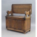 An oak monks bench, early 20th century, the folding top above hinged compartment, 103cm high (top