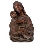 An Italian carved walnut bust length relief of the Madonna and child, 16th century, 36cm high,