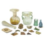 Four Roman glass vessels Circa 1st-4th Century A.D. Two glass unguentaria, one almost clear with