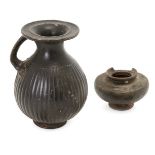 Two black glazed pottery vessels Possibly Greek circa 4th Century B.C. One an olpe, the oval body