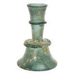 A green glass candlestick, Iran, 15th century, 14.8cm. highPlease refer to department for