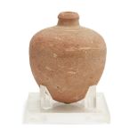 A Bronze Age buff pottery vessel Circa 1500-1200 B.C. With bulbous tapering body, short neck and