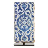 A blue and white Iznik pottery border tile, Ottoman Turkey, circa 1540, of rectangular form, the