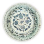 A Timurid blue and white pottery dish, Iran, probably Tabriz, 15th century, with narrow slightly