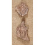 Two Greek terracotta hollow-backed relief fragments, each of a bearded male banqueteer wearing