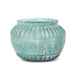 A turquoise glass bowl with moulded Kufic inscription, Iran, 12th century, with rounded sides