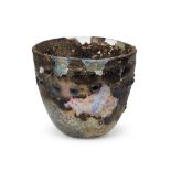 A heavily-weathered late Roman glass beaker, 4th century A.D., decorated with a horizontal row of 17