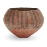 An Iranian pottery deep bowl Circa 4th-3rd Millennium B.C. the swollen body with red slip, sloping