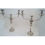 A pair of silver plated candelabra candlesticks, each detachable three branch upper section designed