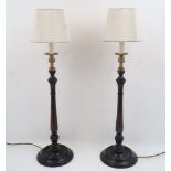 A pair of modern turned wood candlestick lamps, each with brass urn nozzle, shaped shades, 54cm high