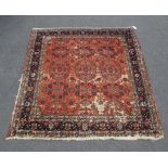 A Persian Bidjar rug, 20th century, the central repeating floral design, on a rouge ground,