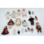 A selection of bisque,celluloid,china miniature, and doll’s house dolls, some on replacement